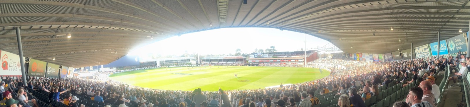 Panoramic view of a crowded stadium at an Australian rules football match